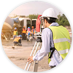 man in white hard hat and yellow traffic vest surveying land